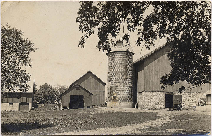  The Joseph Mathews farm sits in between Otsego and Columbus with barns, silo and out buildings on a photo postcard