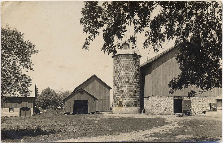 The Joseph Mathews farm sits in between Otsego and Columbus with barns, silo and out buildings on a photo postcard