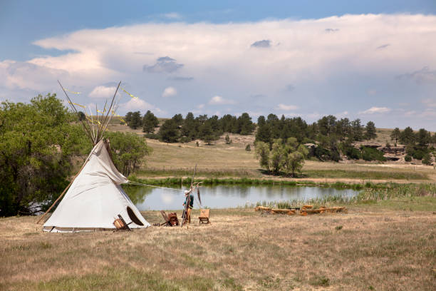 Near Franktown, Colorado on Open Space Day, a Native American tipi stands near a pond with meadows and canyons in the background, part of the 978 acres that make up of open space of Prairie Canyon Ranch in Douglas County.